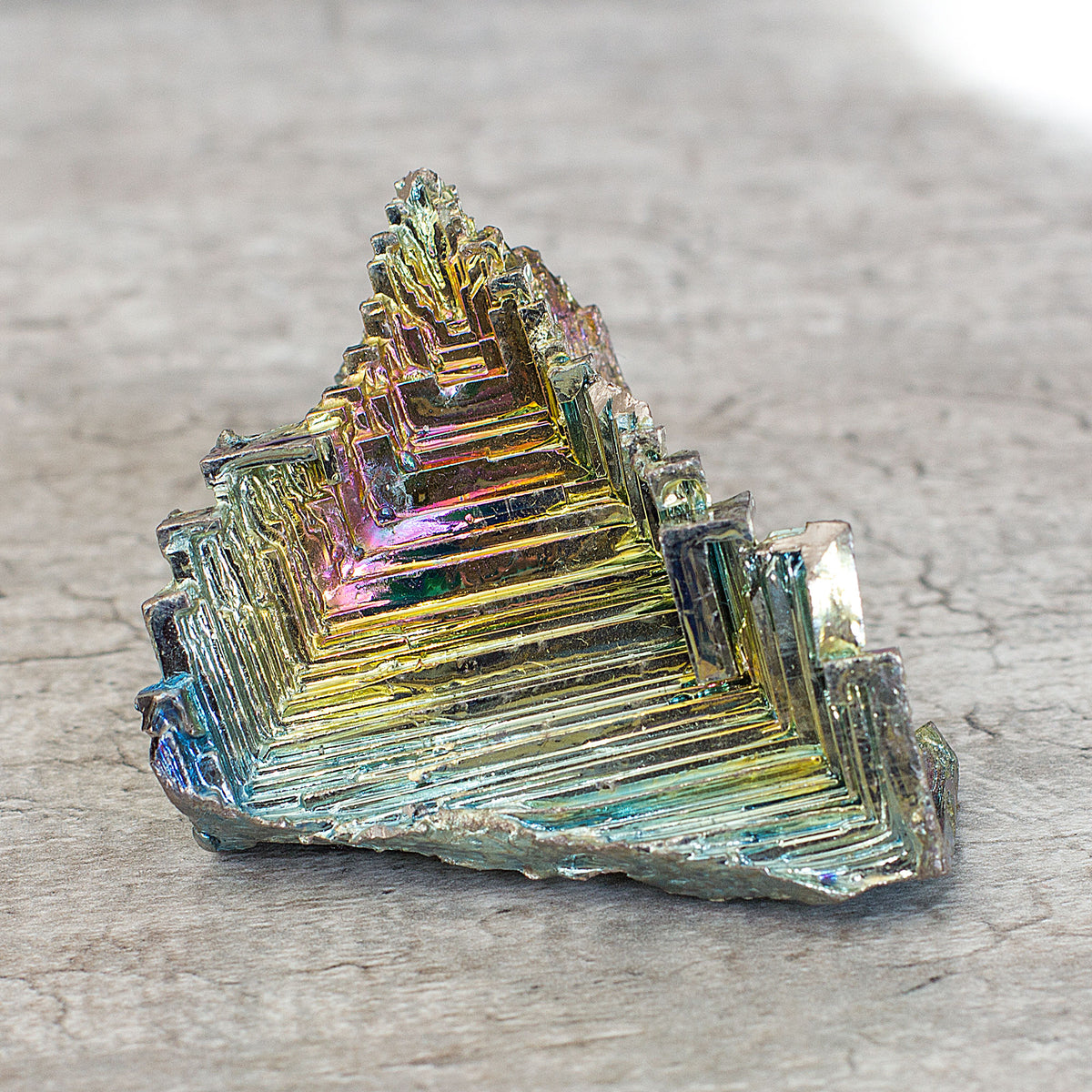 Bismuth is believed to boost energy, vitality, and help achieve goals, especially when working with a team. It is said to aid in transformation by connecting the physical realm with the astral and spiritual planes. Additionally, it is thought to improve visualization during shamanic journeys. Lastly, it is believed to ease feelings of being overwhelmed, isolated, and lonely. Bismuth is often confused with tin and lead, but it is its own element, number 83 on the periodic table. In its natural form, it is a 