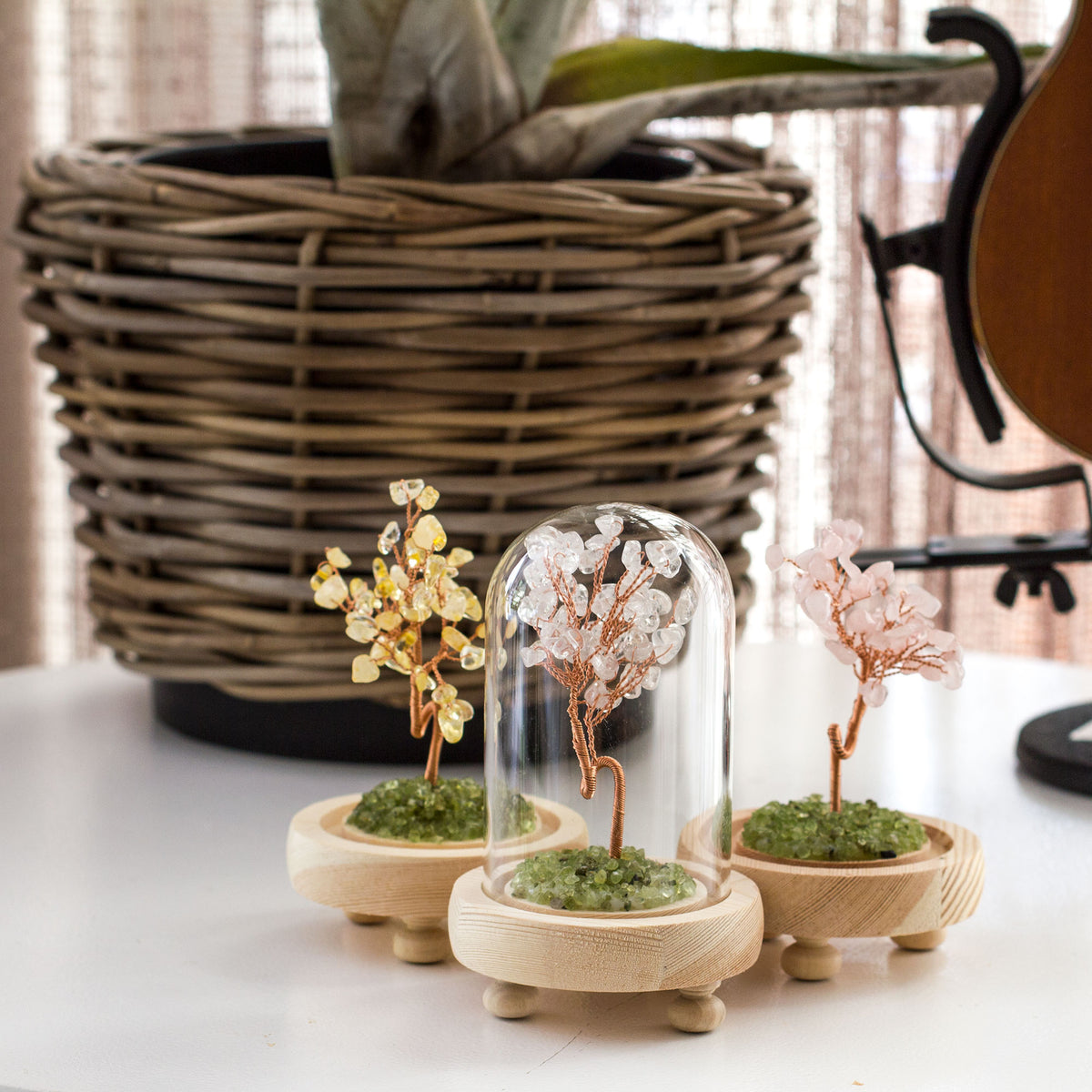 Introducing a truly remarkable piece of art - the sleek, sophisticated, and stunning Crystal Gemstone Tree of Life, crafted with intricate bronze wire and a wooden base. This magnificent creation is adorned with exquisite crystal chips that sparkle and shine beautifully, giving it a unique charm that is second to none. Encased within a glass dome, this masterpiece will add a touch of elegance and refinement to any space, be it your home, office, bathroom, or any other place that deserves a touch of class