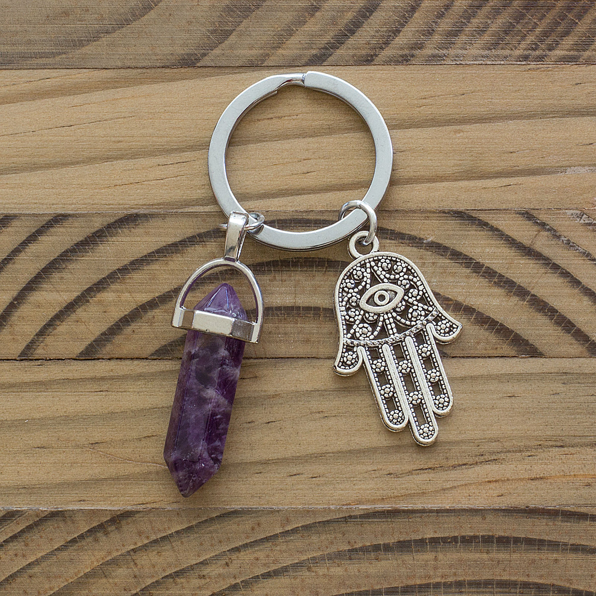 Hamsa Hand Keyring - The Hamsa, also known as the Hand of Fatima, is a symbol of protection in both Jewish and Islamic cultures, linked to Fatima, the daughter of the Prophet Mohammed, and Miriam, the sister of Moses. The word &quot;Hamsa&quot; comes from the Arabic word for &quot;five,&quot; representing the five fingers or points usually shown on the Hamsa. It serves as a powerful reminder to be mindful of our actions and thoughts and their impact on others.