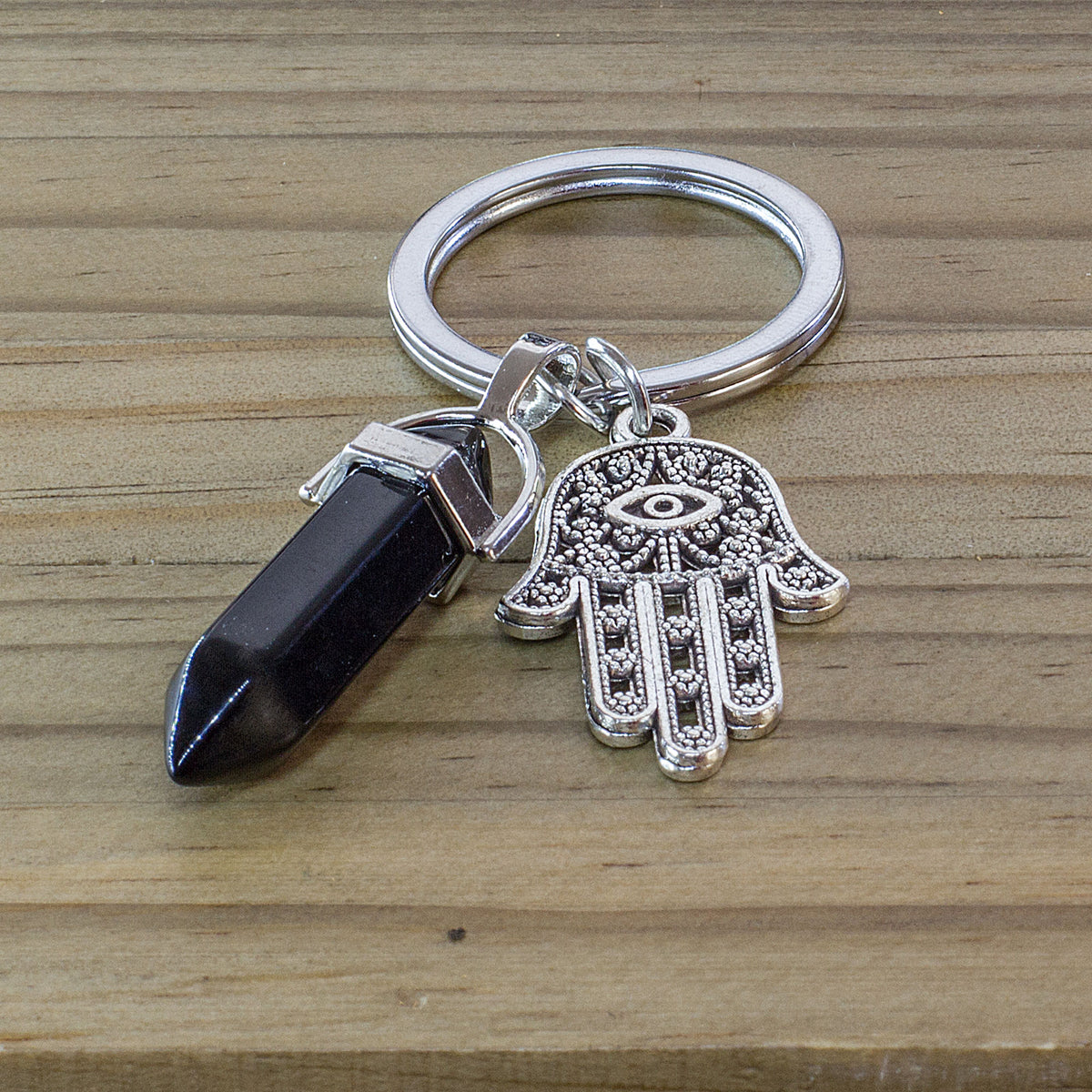 Hamsa Hand Keyring - Black Agate - The Hamsa, also known as the Hand of Fatima, is a symbol of protection in both Jewish and Islamic cultures, linked to Fatima, the daughter of the Prophet Mohammed, and Miriam, the sister of Moses. The word &quot;Hamsa&quot; comes from the Arabic word for &quot;five,&quot; representing the five fingers or points usually shown on the Hamsa. 