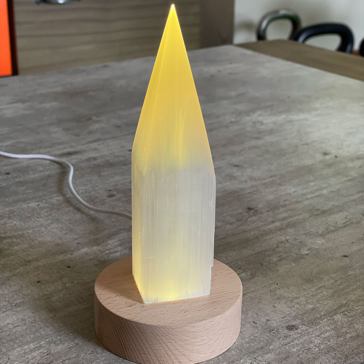 Selenite Lamp - Pencil Point Small - Selenite is a beautiful and versatile crystal that offers numerous benefits, making it a popular choice for both decor and holistic purposes. Its natural beauty and unique translucent appearance make it an eye-catching addition to any home. Selenite emits a soft and warm glow, which makes it an excellent choice for a night light.