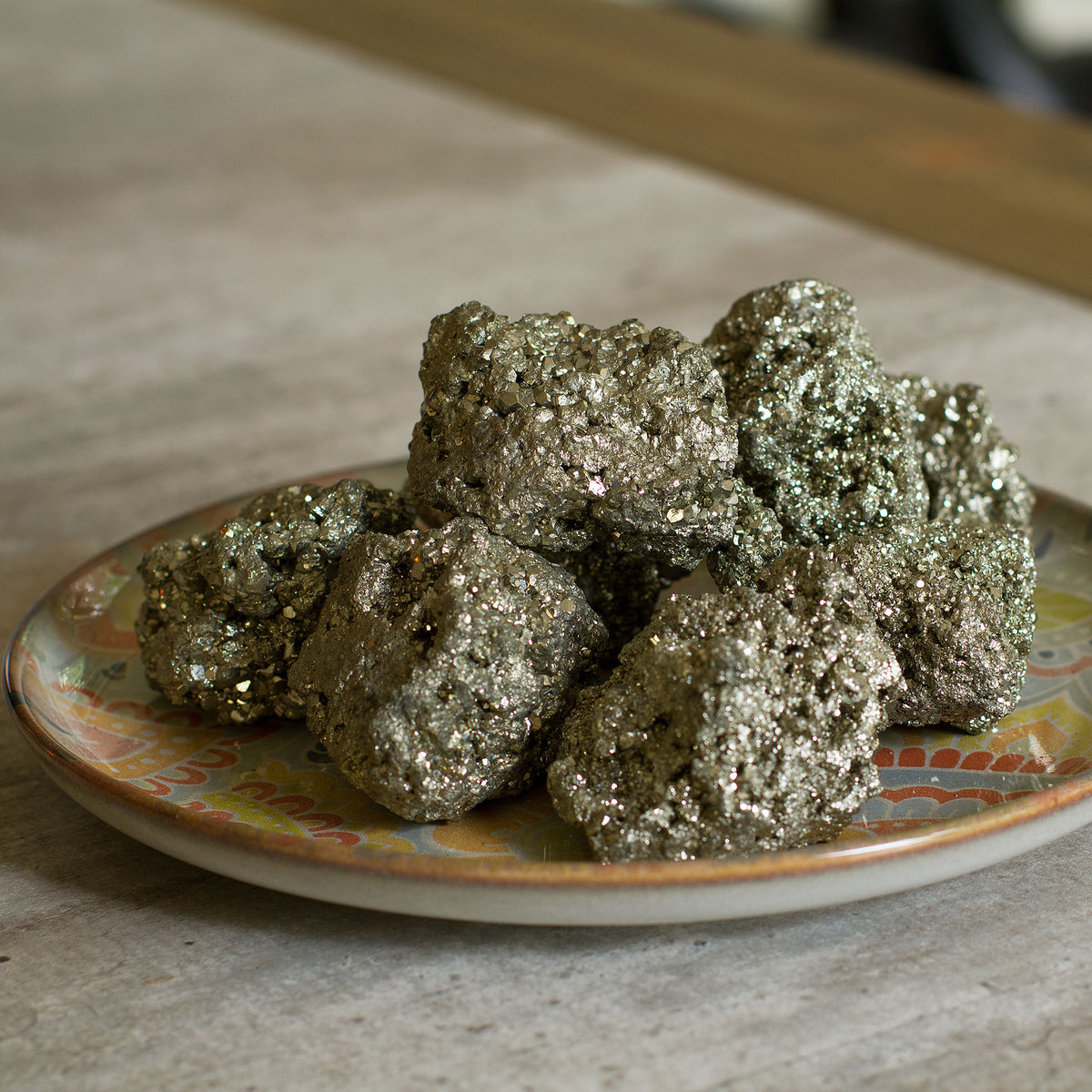 Pyrite Cluster / Druse - +/_ 165g - The term &quot;pyrite&quot; is derived from the Greek word &quot;pyr,&quot; which means fire. This is because the mineral has a distinct golden hue that resembles the color of fire. Pyrite is a fascinating gemstone that has a unique property of producing small sparks when it comes in contact with steel.