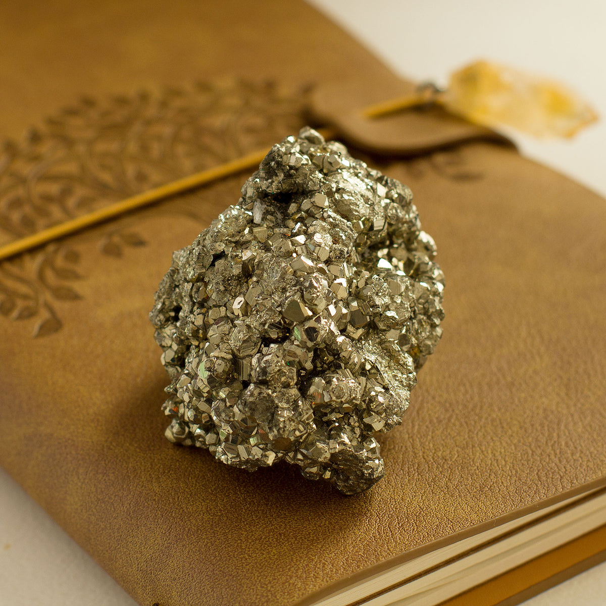 Pyrite Cluster / Druse - +/_ 165g - The term &quot;pyrite&quot; is derived from the Greek word &quot;pyr,&quot; which means fire. This is because the mineral has a distinct golden hue that resembles the color of fire. Pyrite is a fascinating gemstone that has a unique property of producing small sparks when it comes in contact with steel.