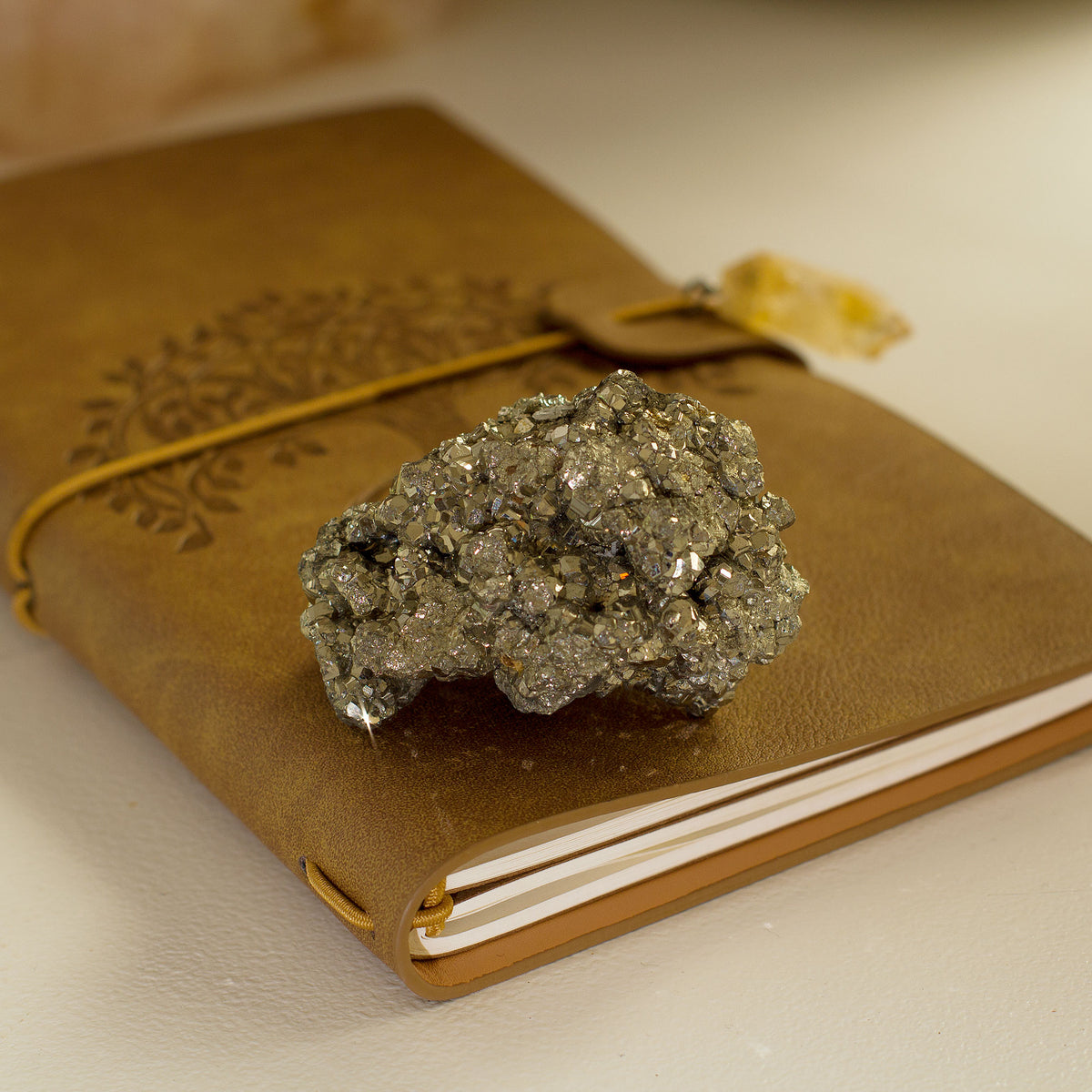 Pyrite Cluster / Druse - +/_ 165g - The term &quot;pyrite&quot; is derived from the Greek word &quot;pyr,&quot; which means fire. This is because the mineral has a distinct golden hue that resembles the color of fire. Pyrite is a fascinating gemstone that has a unique property of producing small sparks when it comes in contact with steel.