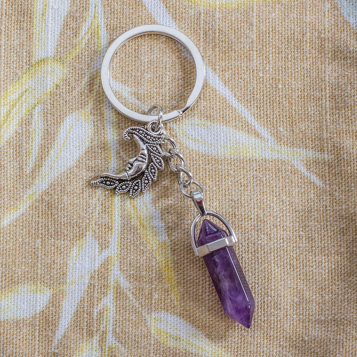 Moon Keyring - Amethyst - The moon is connected to our deepest emotions, representing our spiritual nature and subconscious mind. During a full moon, our intuition, creativity, and emotions are heightened on a spiritual level. Universally, the moon symbolizes the rhythm of time as it goes through its phases, representing immortality, eternity, and both enlightenment and the dark side of nature. In astrology, the moon represents mental and emotional power.