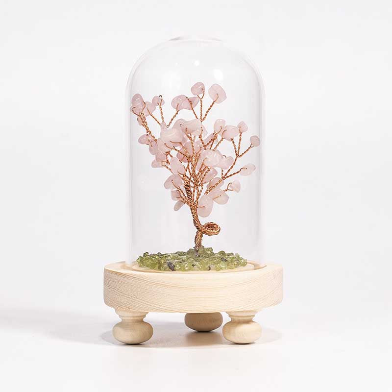 Introducing a truly remarkable piece of art - the sleek, sophisticated, and stunning Crystal Gemstone Tree of Life, crafted with intricate bronze wire and a wooden base. This magnificent creation is adorned with exquisite crystal chips that sparkle and shine beautifully, giving it a unique charm that is second to none. Encased within a glass dome, this masterpiece will add a touch of elegance and refinement to any space, be it your home, office, bathroom, or any other place that deserves a touch of class