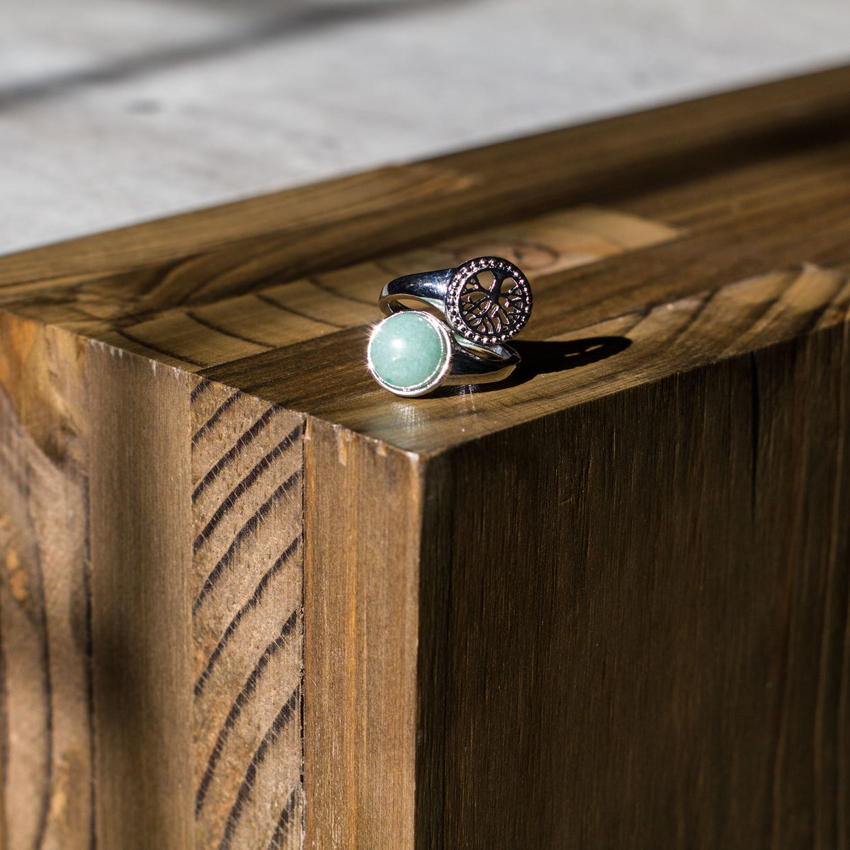 Are you drawn to the calming and grounding influence of crystals, and the liberating lifestyle they symbolize? If so, immerse yourself in the sheer beauty of our exclusive assortment of crystal rings. These exquisite wrap-around adjustable rings are a sight to behold, featuring a dazzling tree of life intricately set in a mesmerizing circular pattern, accentuated by a captivating and flawlessly cut round cabochon crystal at its center.