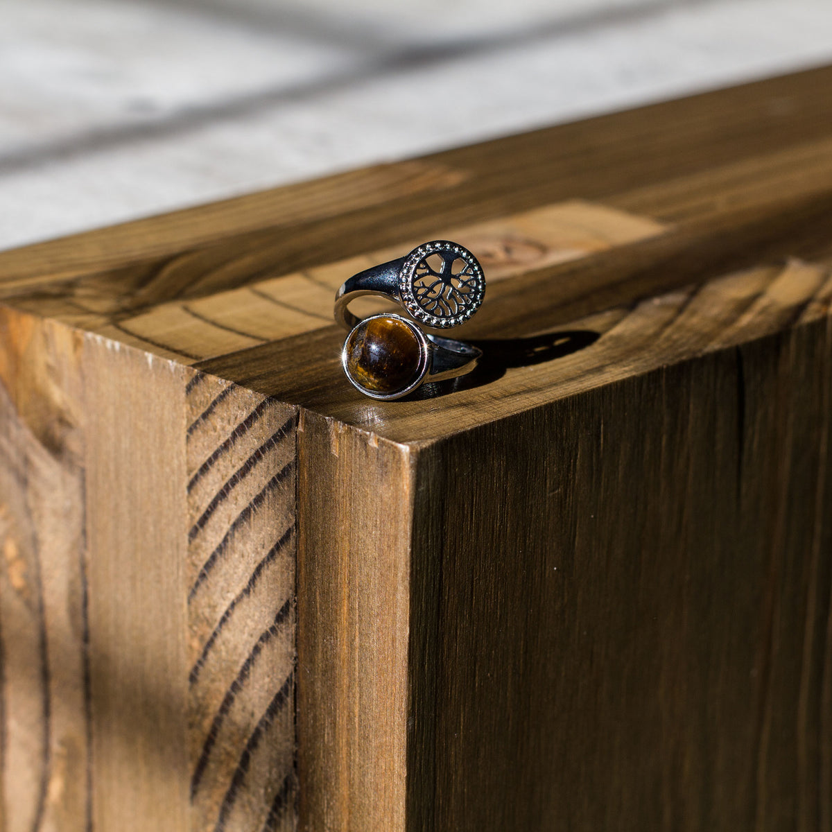 Are you drawn to the calming and grounding influence of crystals, and the liberating lifestyle they symbolize? If so, immerse yourself in the sheer beauty of our exclusive assortment of crystal rings. These exquisite wrap-around adjustable rings are a sight to behold, featuring a dazzling tree of life intricately set in a mesmerizing circular pattern, accentuated by a captivating and flawlessly cut round cabochon crystal at its center.