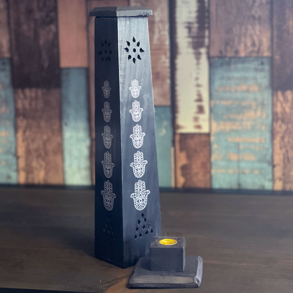 A multipurpose Stylish wooden holder to place an incense cone or Stick into. Simply remove the gold plate to insert an incense stick in the middle or place an incense cone on the plate in the center. Watch as the smoke escapes through the holes of this Stunning Tower Holder.